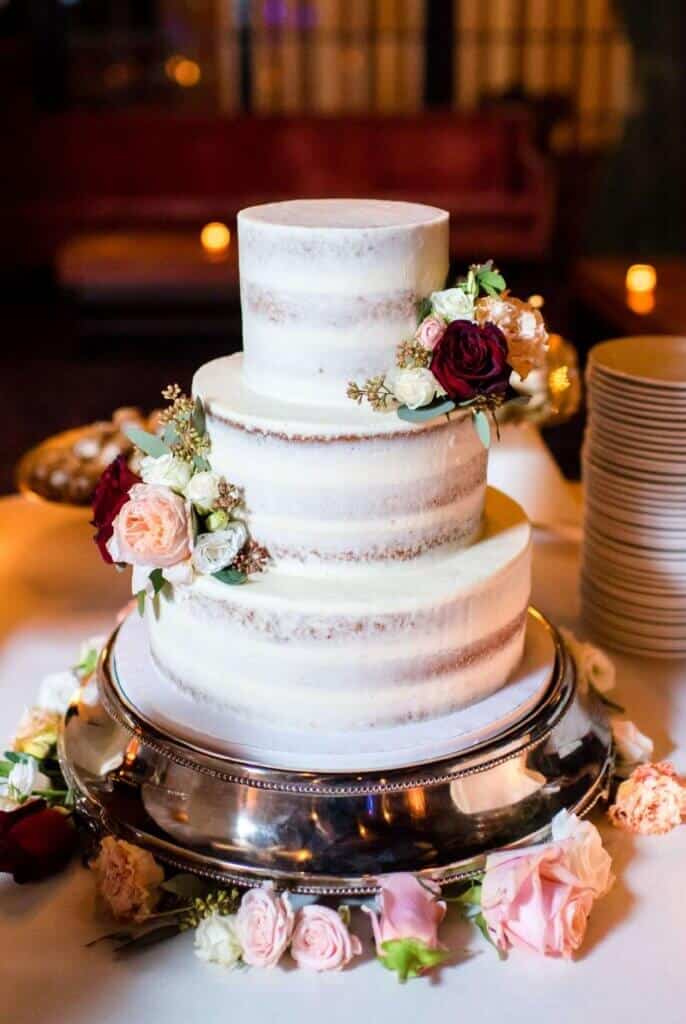 半裸体婚礼蛋糕和鲜花的照片