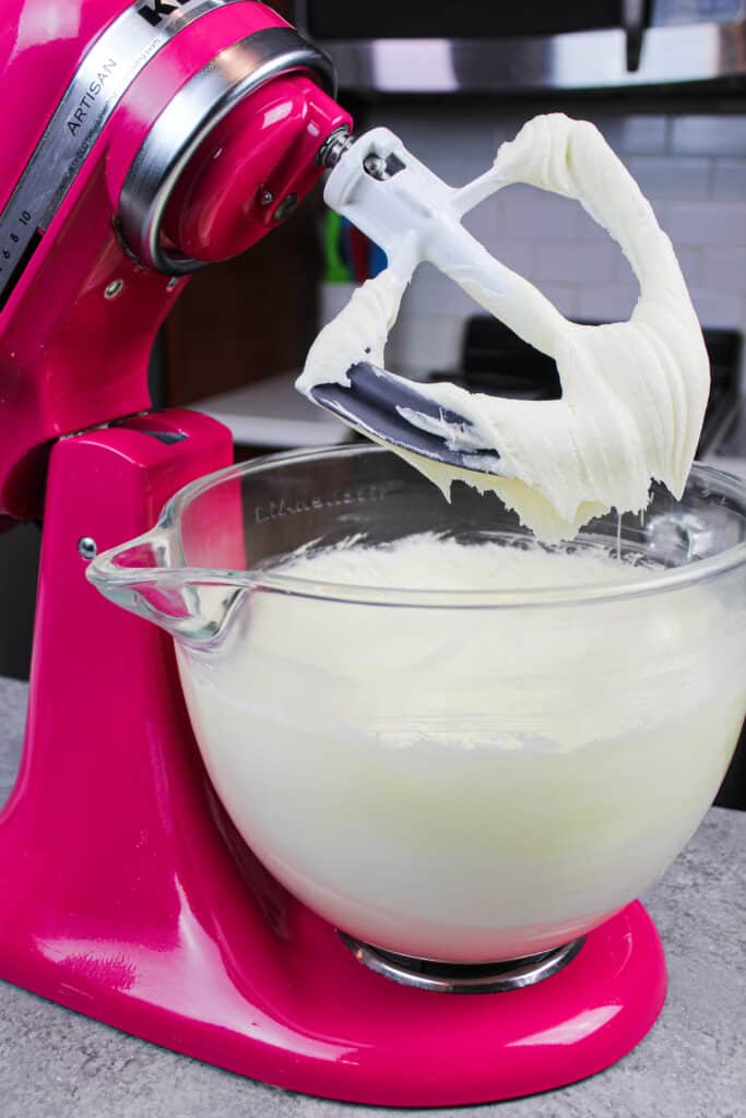 白色巧克力奶油糖霜在厨房辅助设备中用桨连接制作的图像