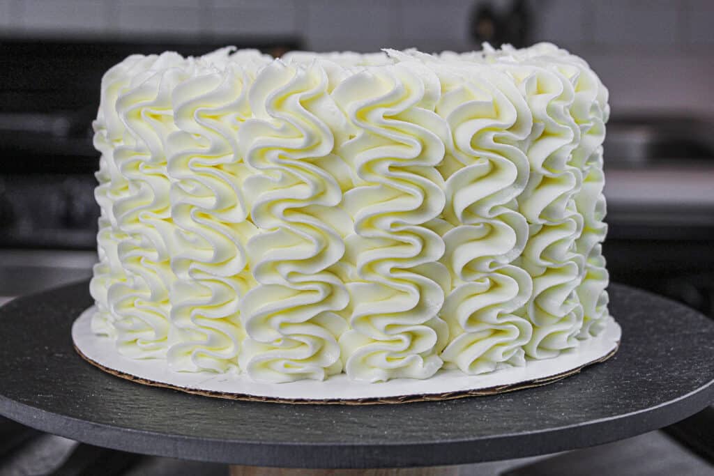 image of gluten free layer cake  frosted with a wilton 1M frosting tip
