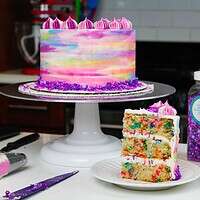 image of vegan confetti cake slice and frosted cake for a birthday