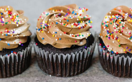 巧克力意大利蛋白酥皮乳酪乳酪的图象在巧克力杯形蛋糕顶部结霜