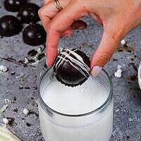 热可可炸弹被放在一杯温暖牛奶中的图像