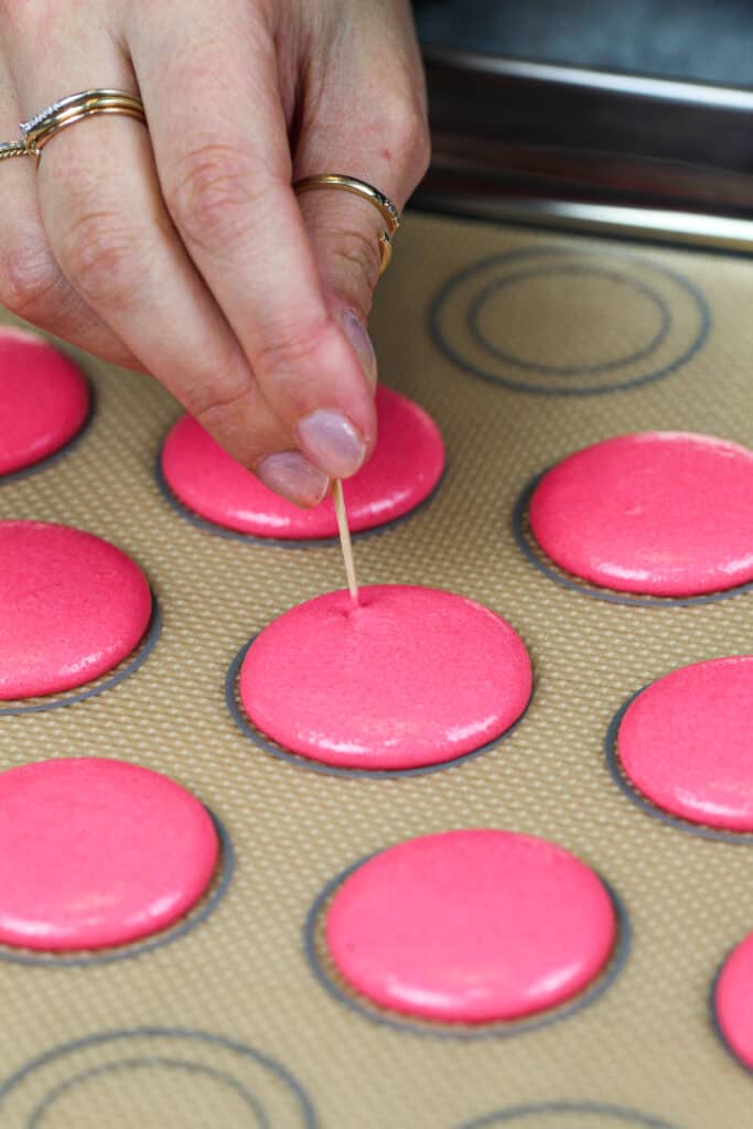 粉红色的马卡龙贝壳的图像，并用牙签弹出气泡