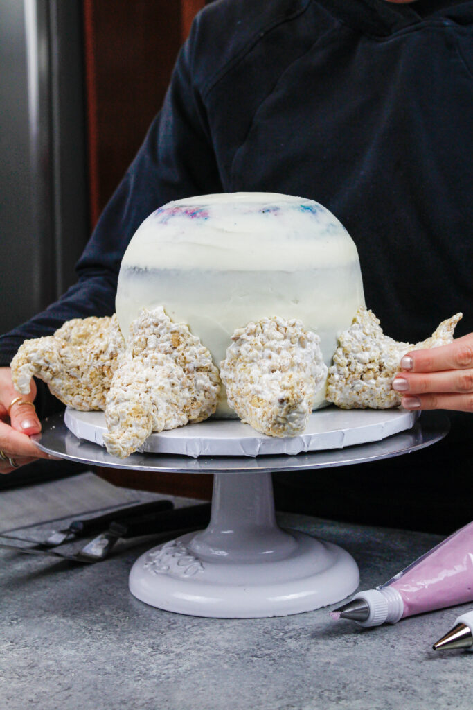 图片中的章鱼蛋糕是由彩色的蛋糕层，奶油和蛋糕装饰米花