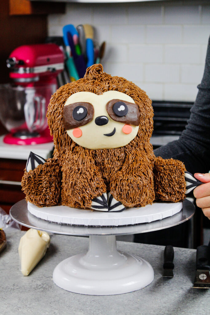 这是一个树懒生日蛋糕，由巧克力蛋糕层、巧克力、花生酱、奶油和方糖指甲做成