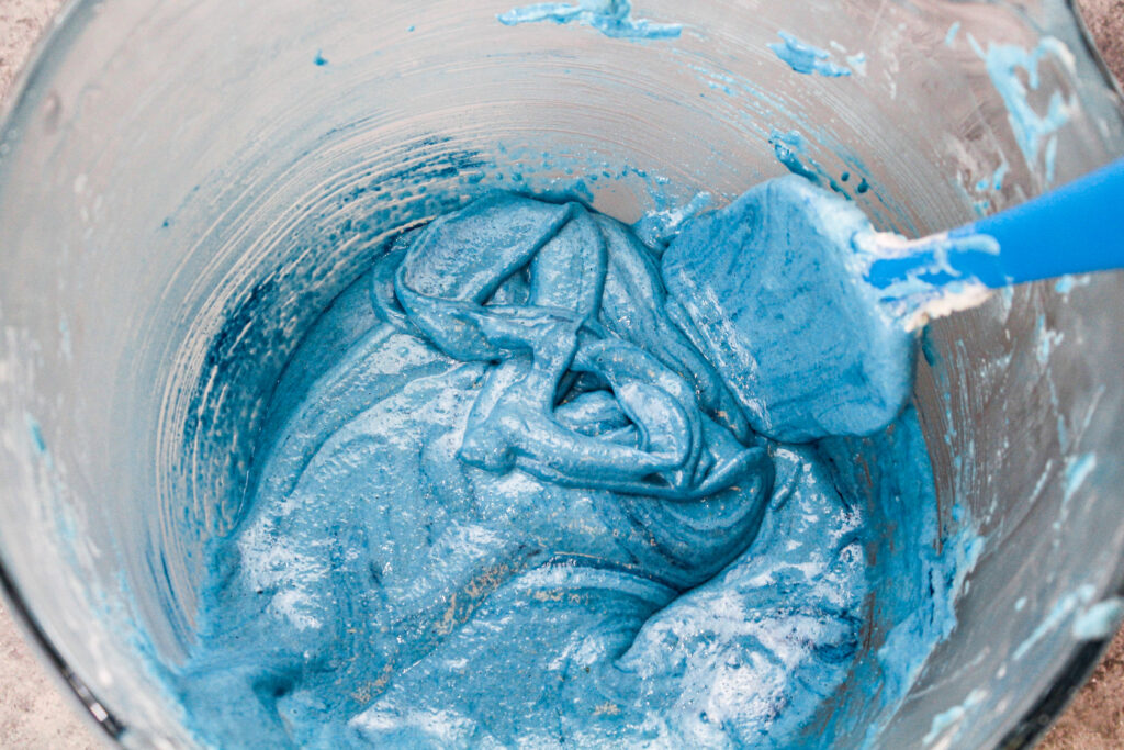 蓝莓蓝色的马卡龙面糊已经混合到合适的稠度，当面糊从抹刀上流出时，可以用来在碗里画出图8s