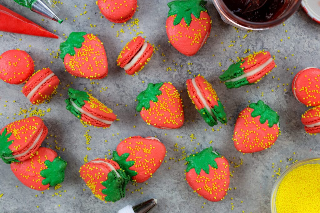 可爱的法国草莓macarons的图象充满buttercream和草莓酱