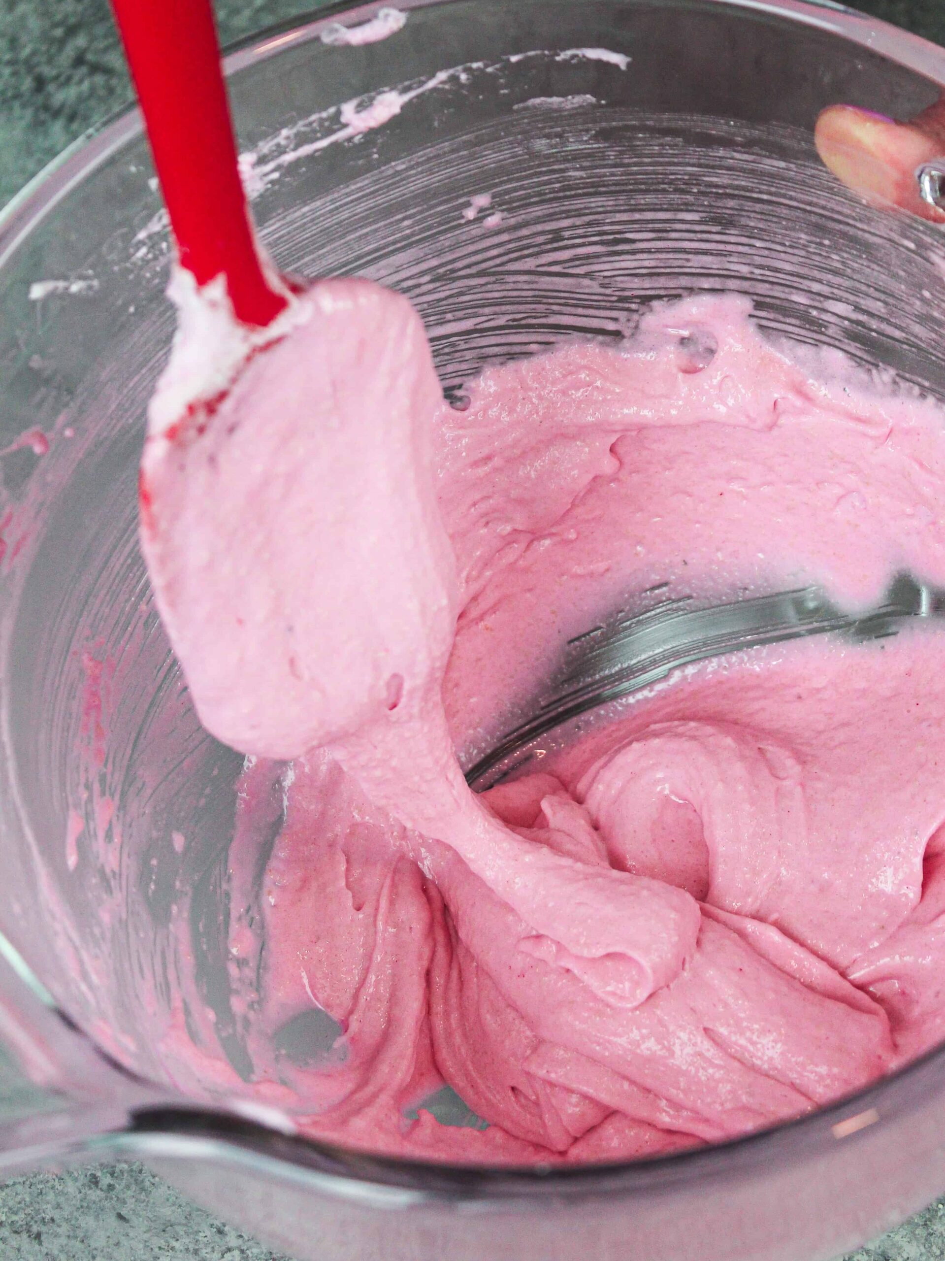 image of pink french macaron batter being mixed to make birthday cake  macarons